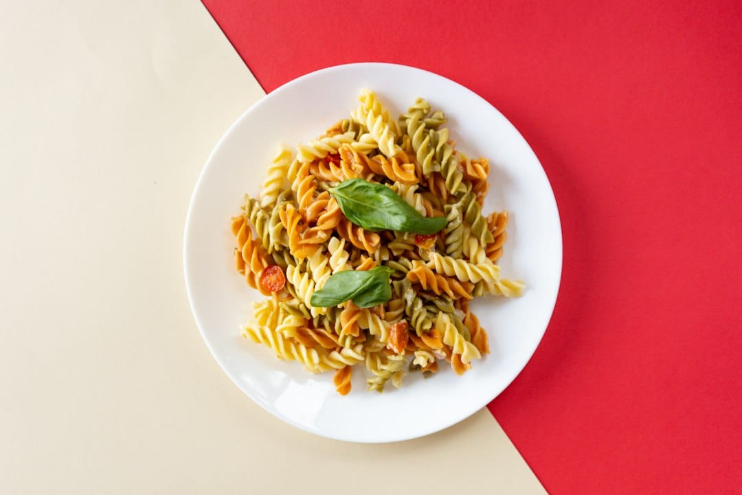 Cold pasta lunchbox with colorful rotini and simple kid-friendly sides